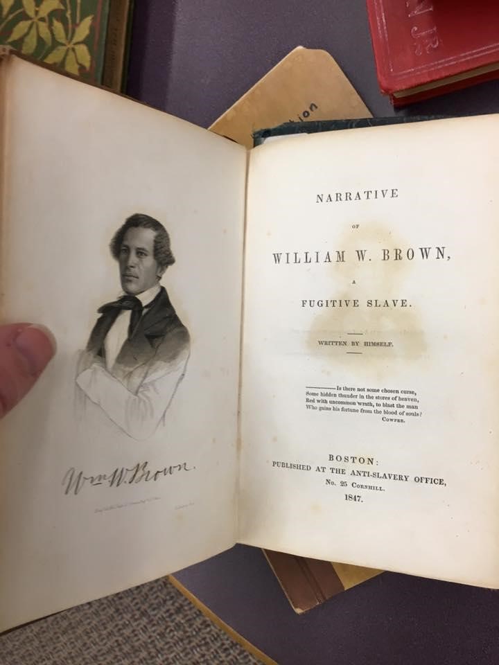 An individual holds the first edition of William Wells Brown’s Narrative of William Wells Brown, A Fugitive Slave (1847)